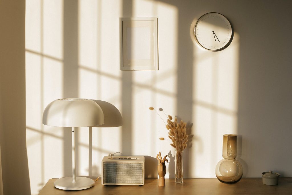 room interior with lamp and vases on table near wall